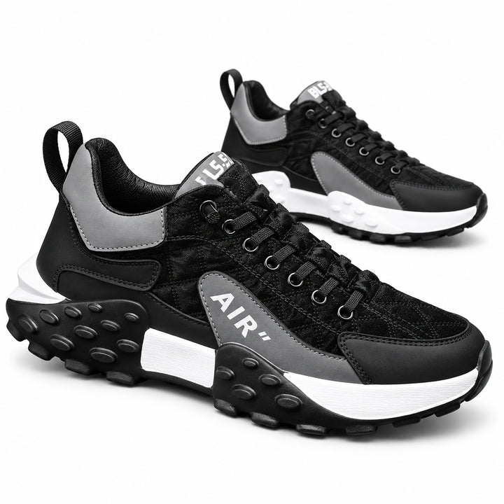 Black and Gray lace-up sneakers shown as a pair with contrasting white midsole sections and black sculpted soles in a studio.