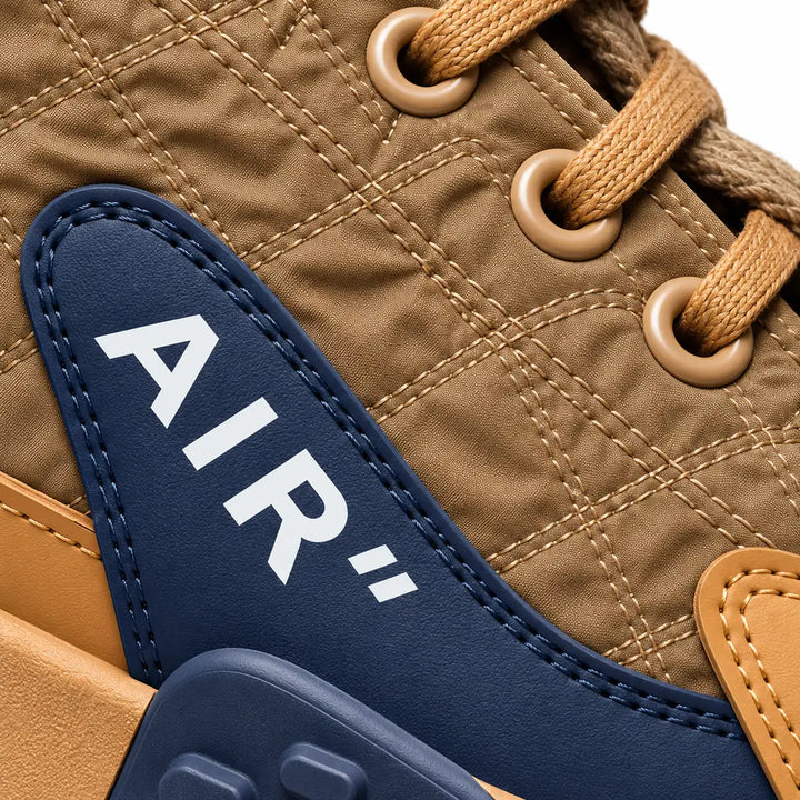 Brown and Navy sneaker showing patterned upper panels, stitching, laces and the AIR side detailing against a white background