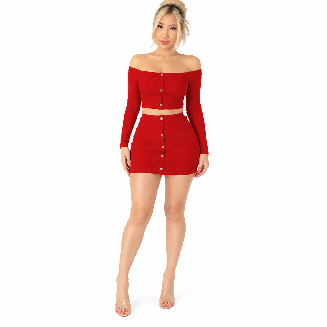 Red crop top and matching mini skirt with silver buttons on a standing model