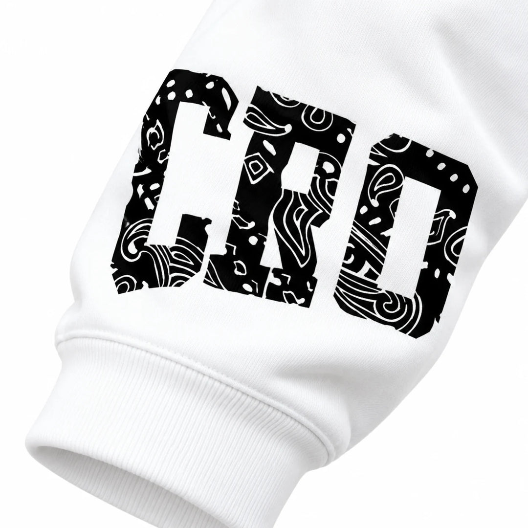 Close-up of patterned black sleeve lettering and the white ribbed cuff