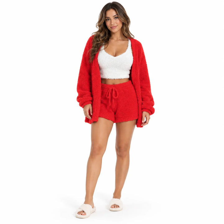 Flannel pajama set in bright red on a studio model, with a white cropped vest, long sleeve coat and drawstring lounge shorts.
