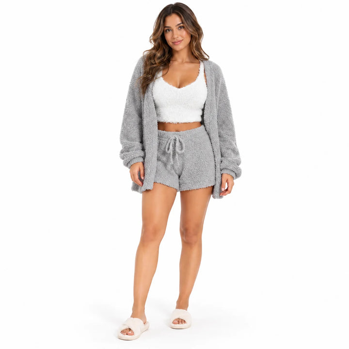 Full-body model wearing a light gray lounge coat and shorts with a white cropped vest, front view on white studio background.