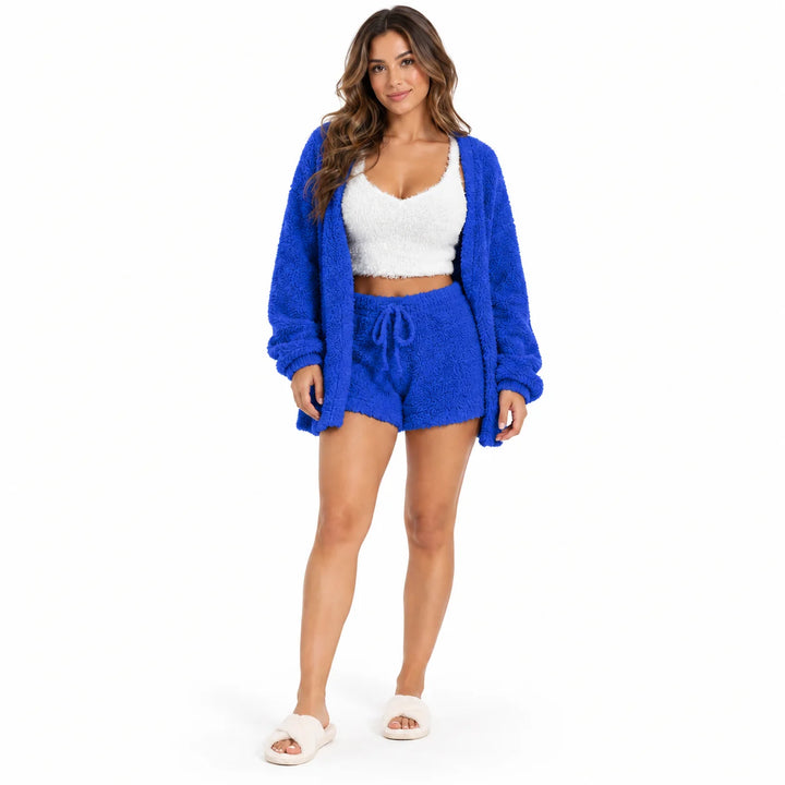 Full-body model wearing a royal blue lounge coat and shorts with a white cropped vest, front view on white studio background.