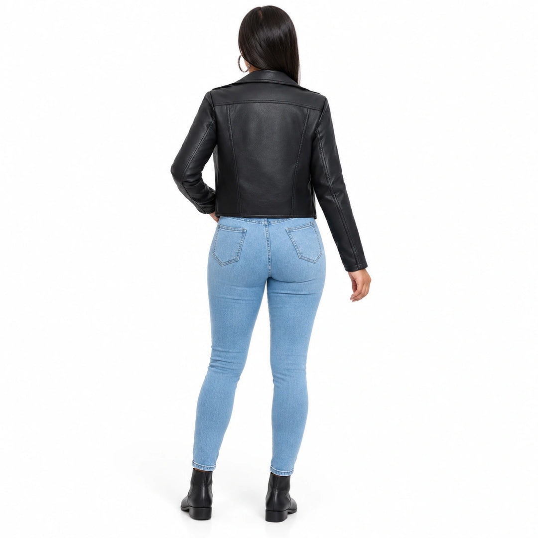 Black moto jacket shown from the back on a full-body model, highlighting shoulder yoke, vertical seams and long sleeve shape.