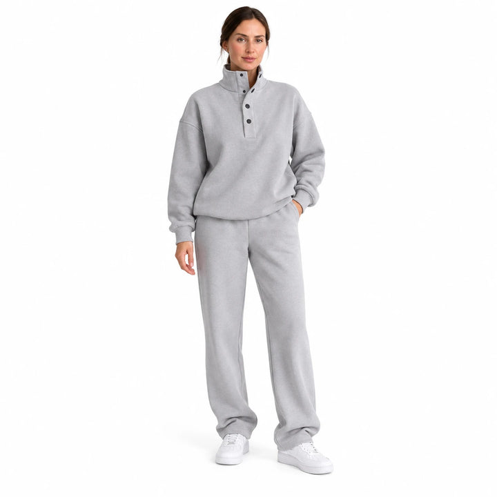 Gray matching set with a stand collar and dark buttons, worn by an adult model in a front view against a pure white backdrop.