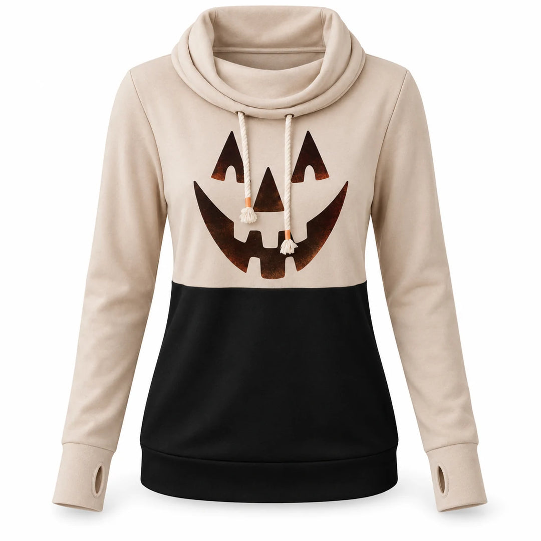 Pumpkin top in beige and black shown from the front on a white background with long sleeves, drawstrings and graphic visible.