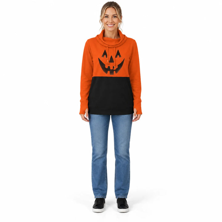 Woman wearing the pumpkin orange and black printed pullover with jeans and black shoes in full-body front view against white.