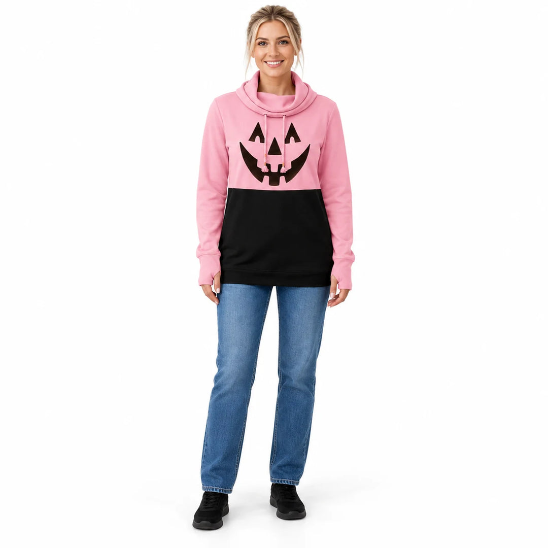Woman wearing the soft pink and black pumpkin print pullover with blue jeans and black shoes in a full-body front studio view