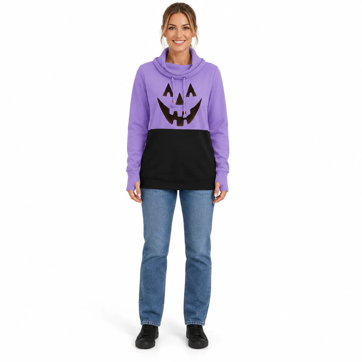 Woman wearing the lavender purple and black printed pullover with jeans and black shoes in a full-body front view in a studio