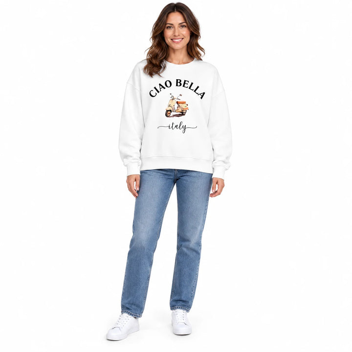 Graphic fleece sweatshirt in white on a full-body female model, showing Ciao Bella scooter print, long sleeves and loose fit.