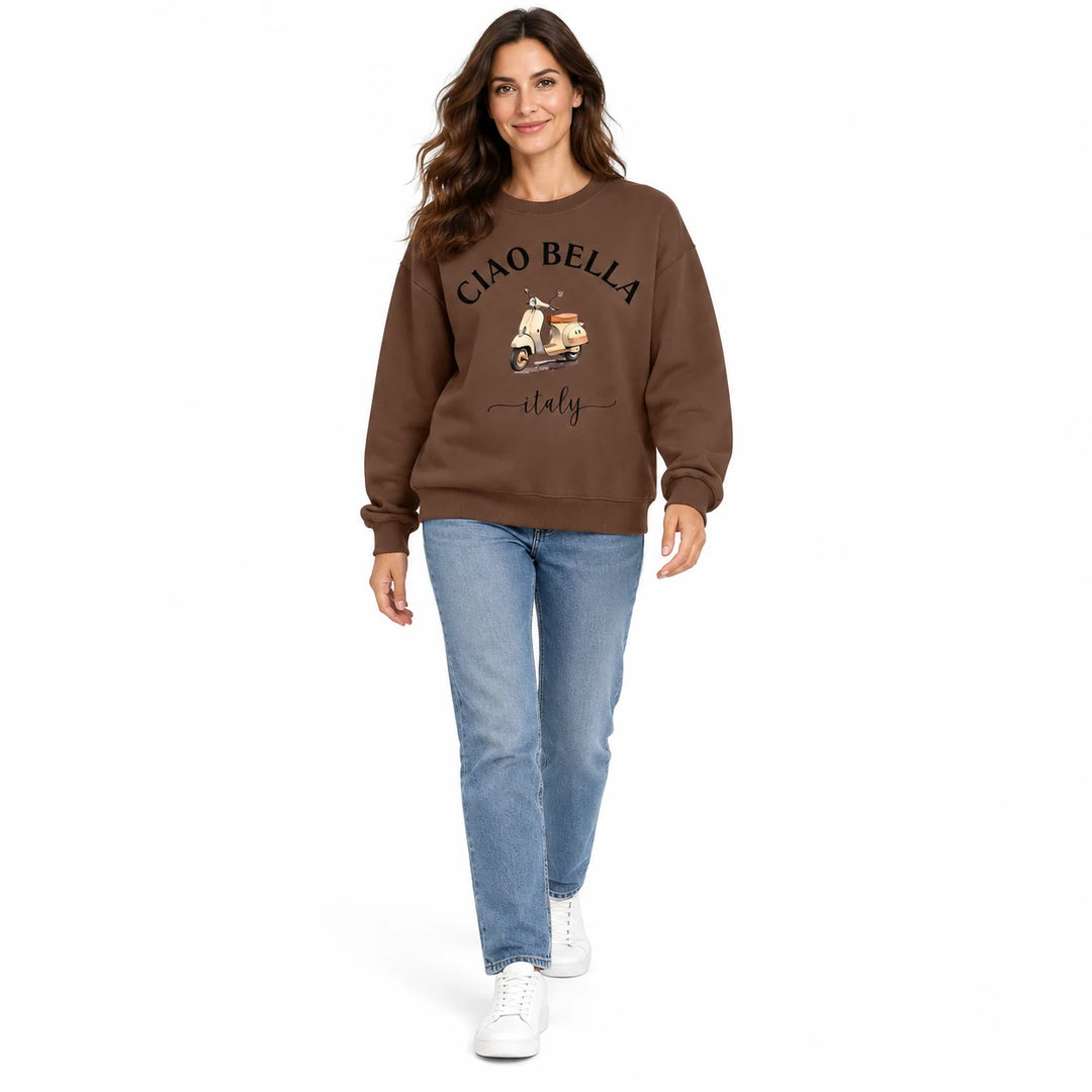 Coffee brown Ciao Bella sweatshirt shown on a full-body female model walking in white studio, with the scooter print visible.