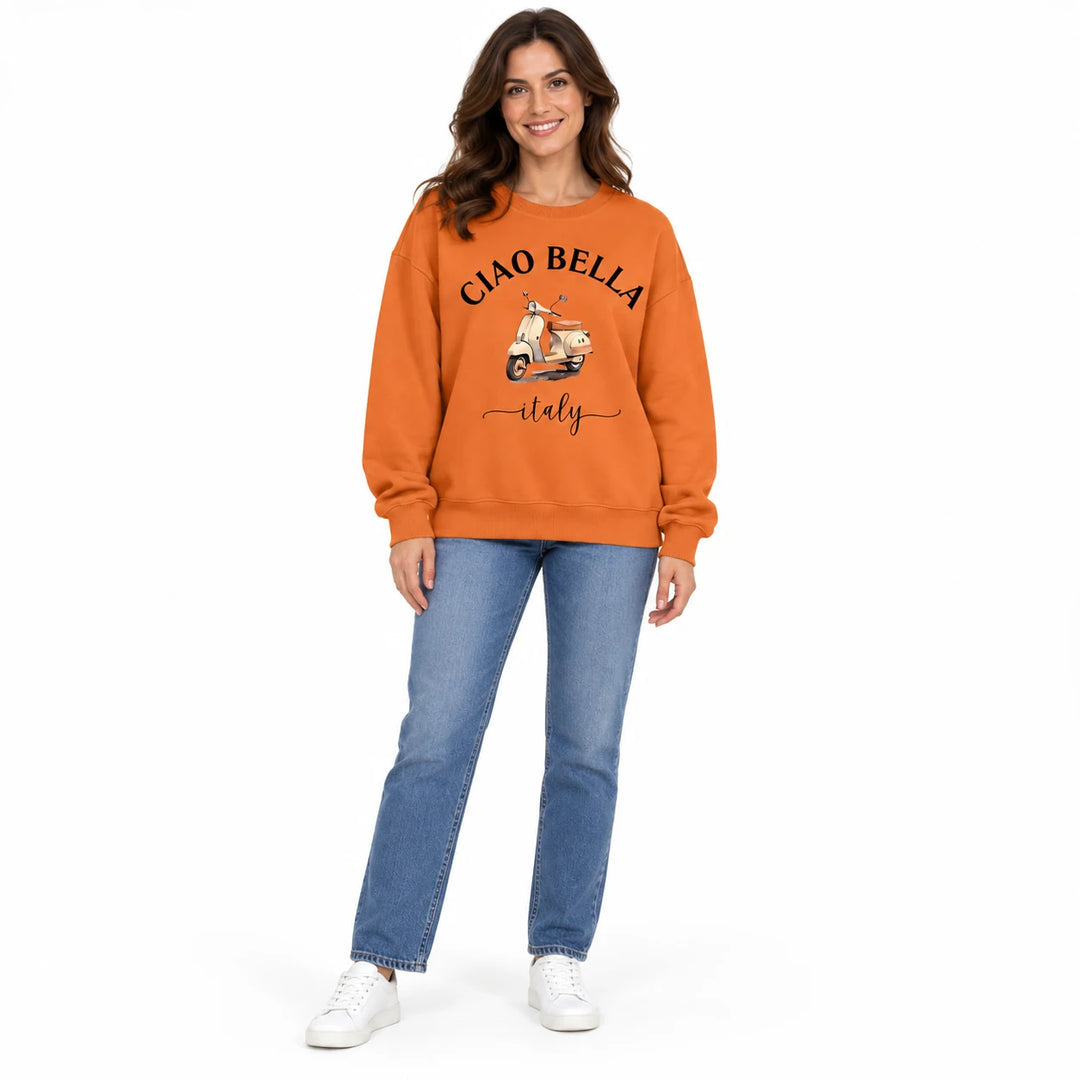 Orange Ciao Bella scooter print sweatshirt with black lettering, shown on a female model in jeans against a white background.