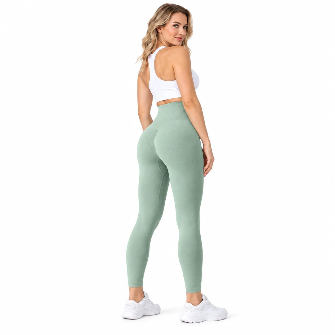 Full-length model in Army Green high-waisted leggings in a rear three-quarter view, with a white crop top and white trainers.