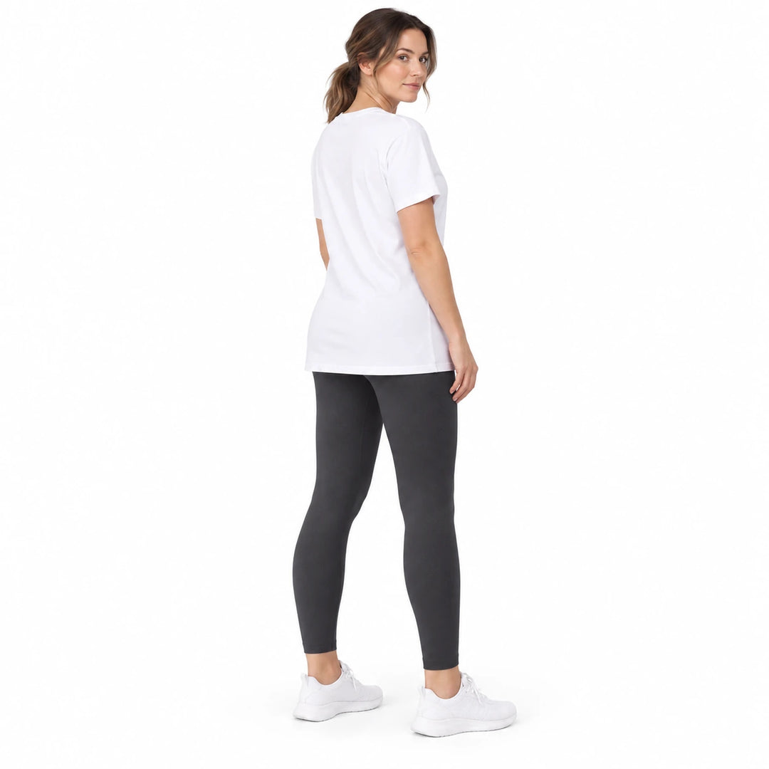 Adult model in White Blue contoured leggings, a long white T-shirt and white trainers, standing on a white studio background.