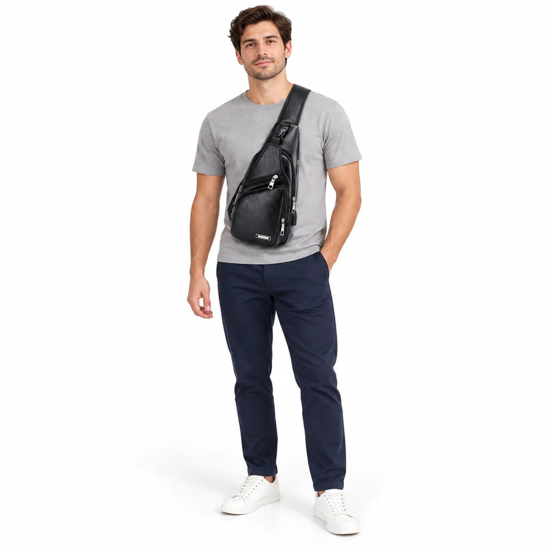 Full-body male model wearing the Black sling bag across his chest, showing its front zipped pockets against a white backdrop.