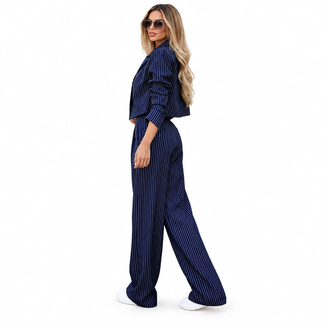 Dark blue matching set with a cropped lapel jacket, shown on an adult model in a side pose against a white studio background.