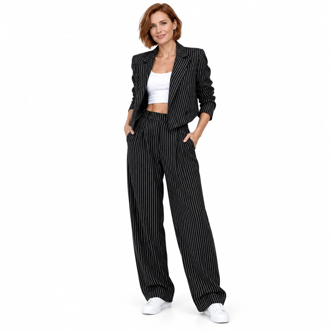 Black matching set with a cropped lapel jacket, shown on an adult model in a standing pose against a white studio background.
