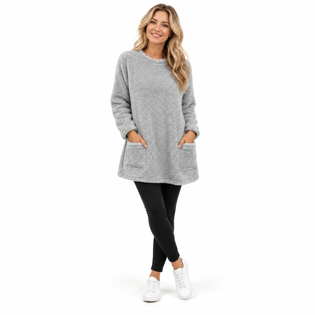 Light Gray long fleece pullover worn by an adult woman, with a round neck and front patch pockets, in a white studio setting.