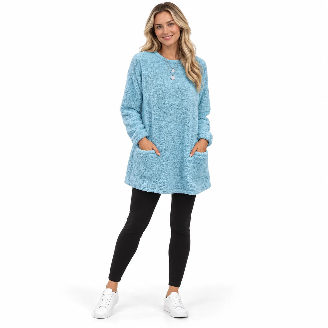 Blue long fleece pullover worn by an adult woman, with a round neck and front patch pockets, against a pure white background.