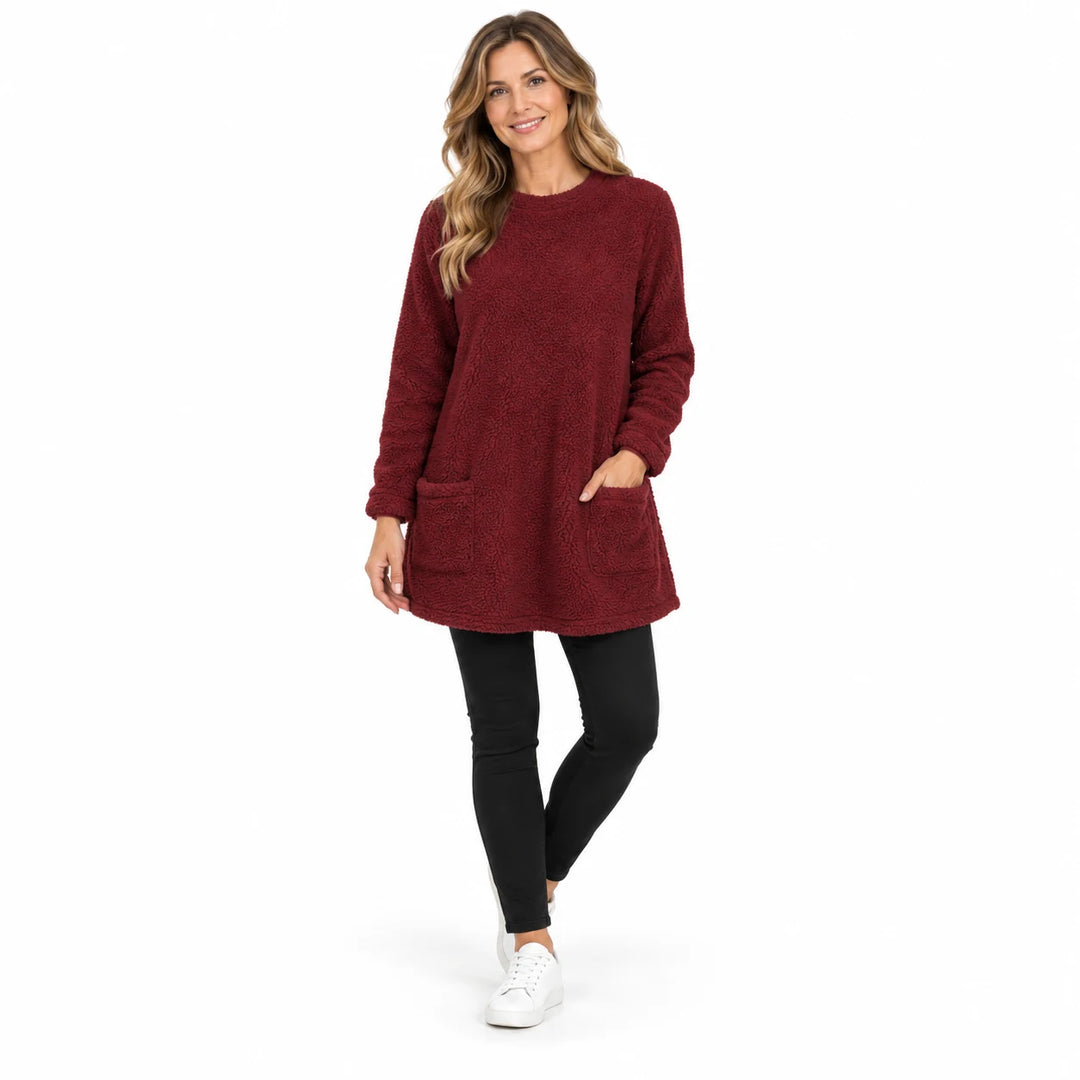 Burgundy long fleece pullover worn by an adult woman, showing long sleeves and two front pockets, against a white background.