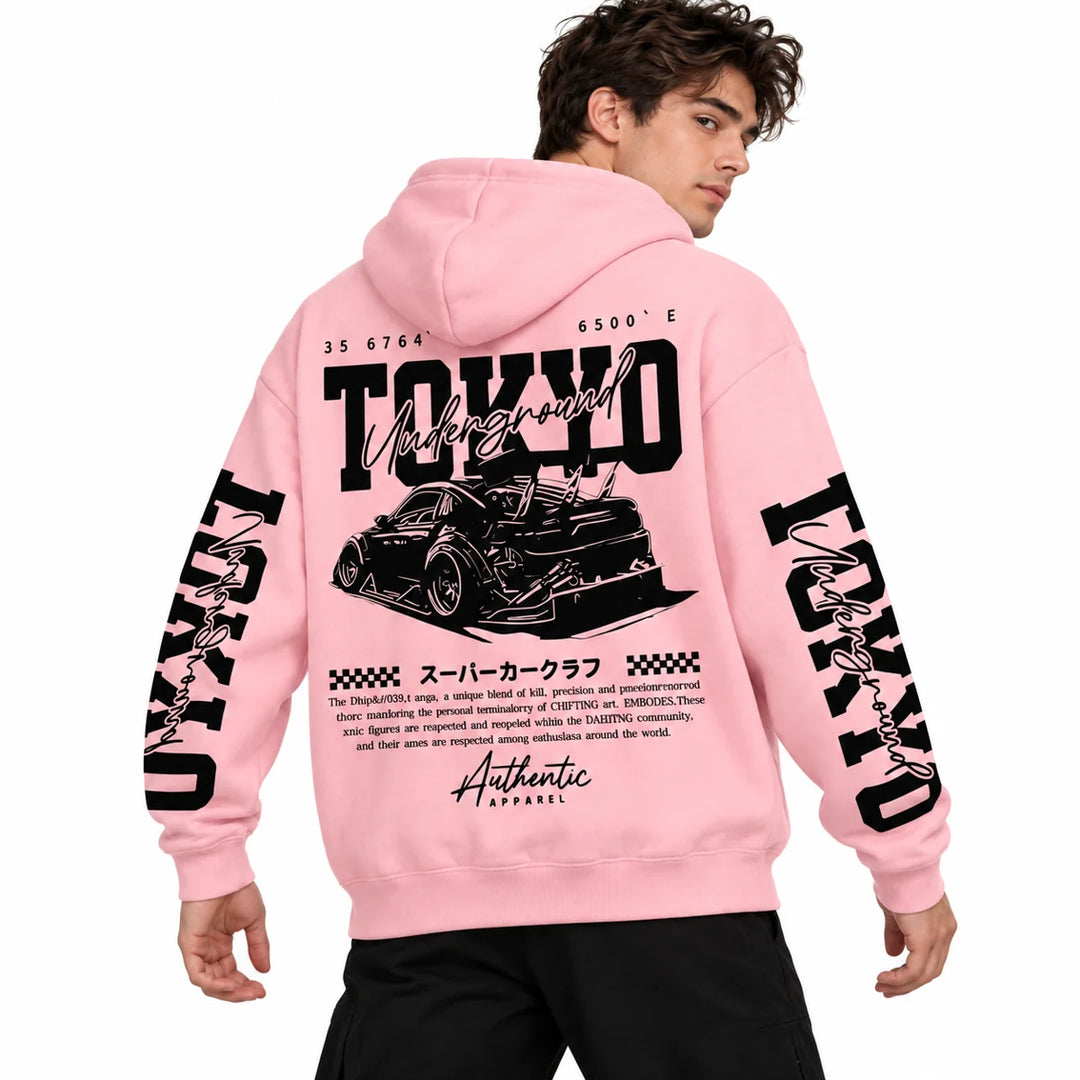 Male model wearing Light Pink Tokyo racing graphic hoodie, showing back artwork and sleeve prints