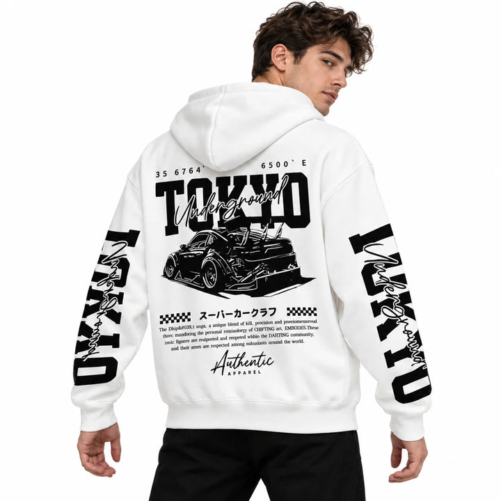 Male model wearing White Tokyo racing graphic hoodie, showing back artwork and sleeve prints