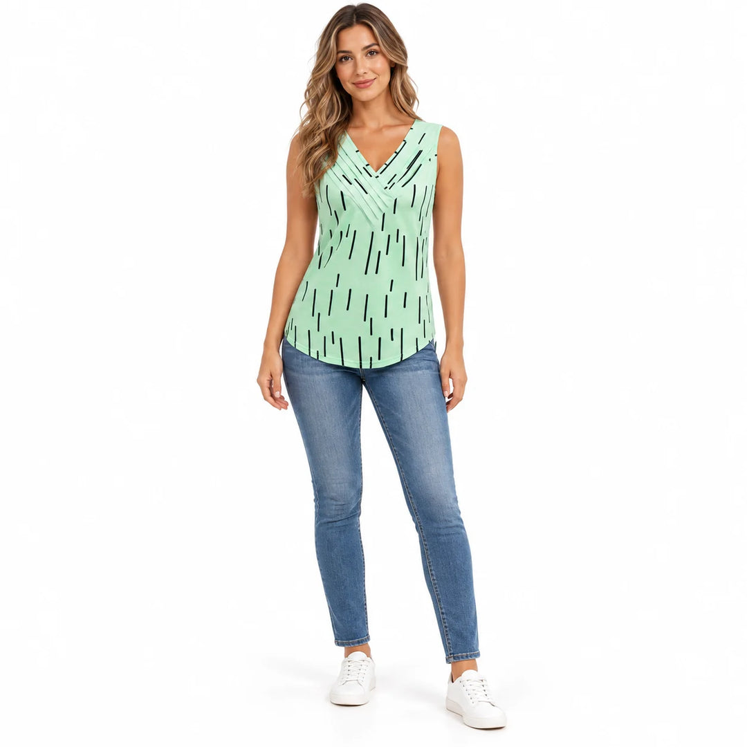 V neck tank top in Mint Green on a full body model in jeans, black dash print and crossover neckline, white studio background
