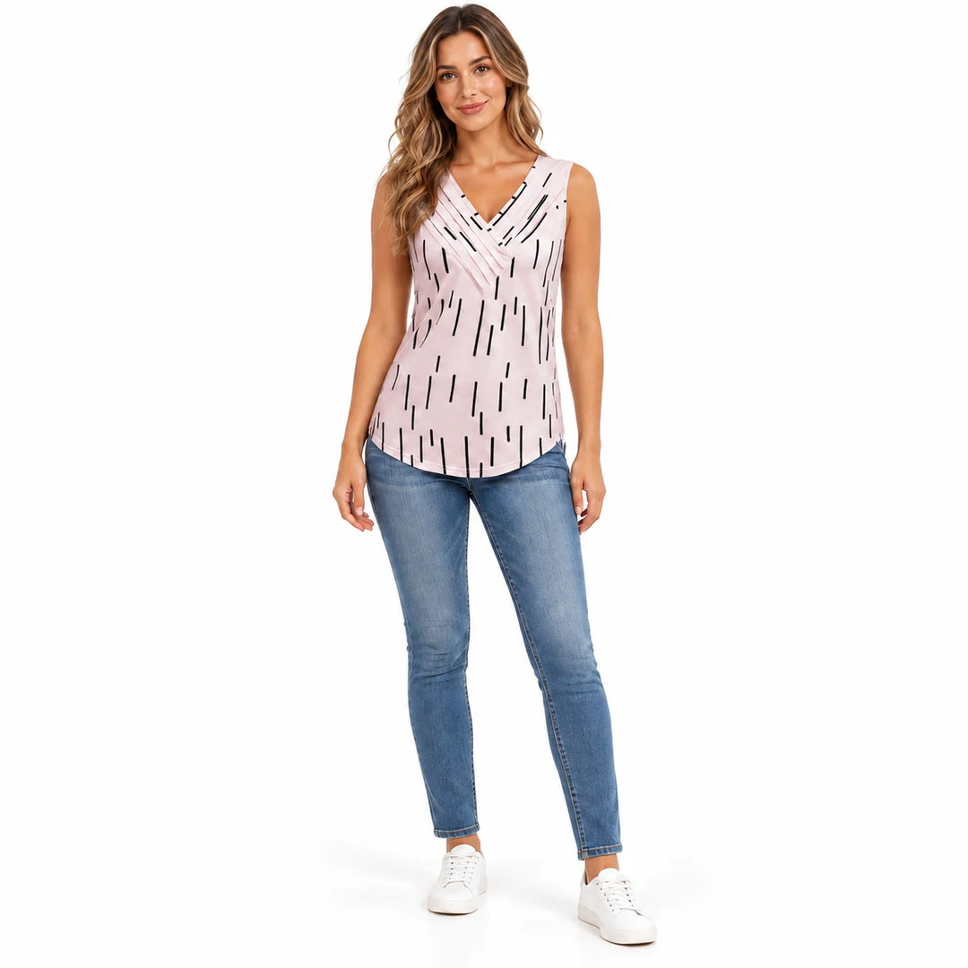 V neck tank top in Blush Pink on a full body model in jeans, black dash print and crossover neckline, white studio background
