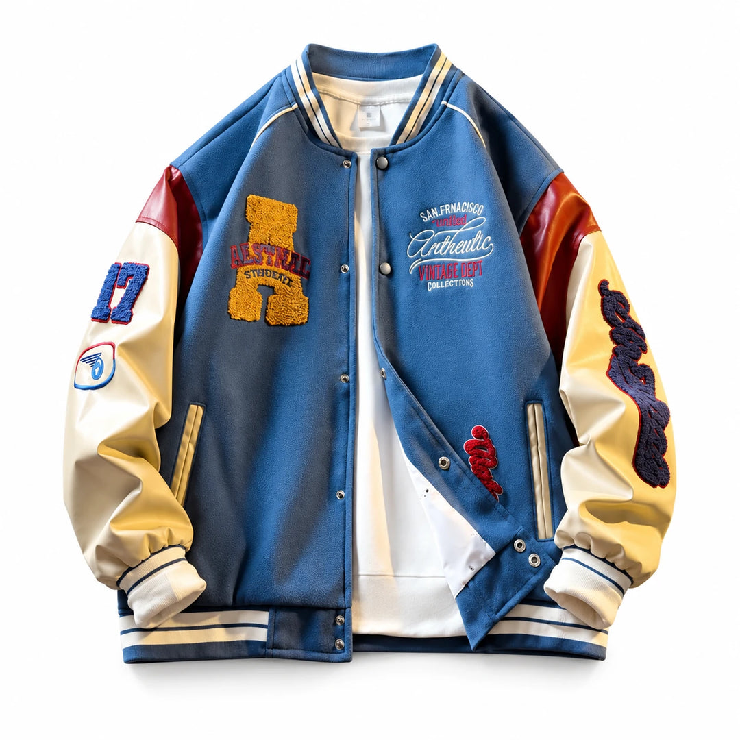 Blue varsity jacket front view with cream sleeves, red shoulder panels, embroidered patches, snap buttons and ribbed trim.