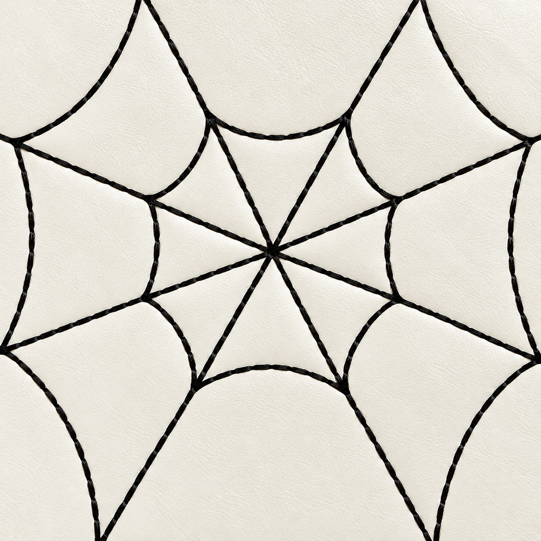 Close view of black spiderweb lines on the white PU handbag front, showing the intersecting center and visible surface detail
