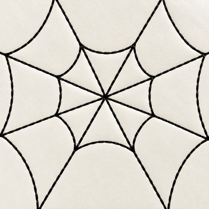Close view of black spiderweb lines on the white PU handbag front, showing the intersecting center and visible surface detail