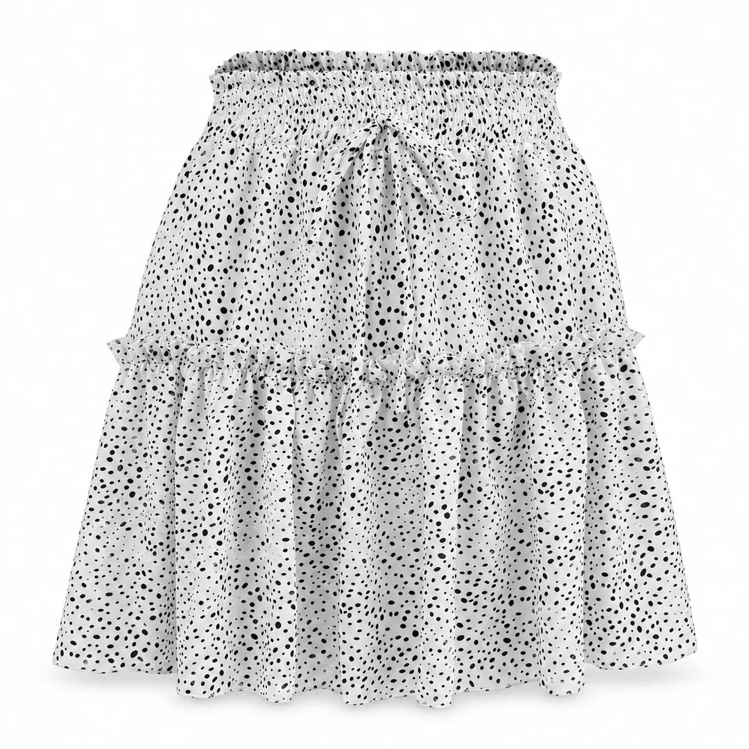 White polka dot pleated skirt with a gathered waistband, front tie and ruffled lower tier