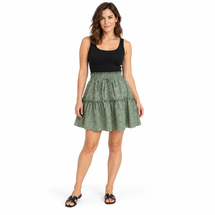 Model wearing the green polka dot chiffon skirt with a black top and sandals