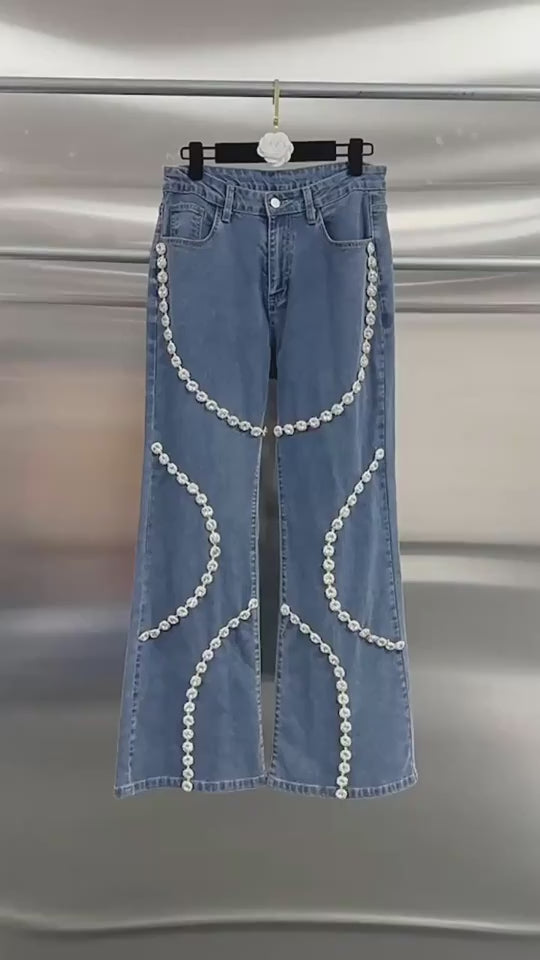 Blue mid-rise jeans for women with rhinestone accents, straight legs, full trouser length and nonelastic cotton denim fabric.
