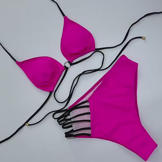 Close-up shot of the halter neck bikini’s nylon fabric and cutout strap details as the model moves by the pool