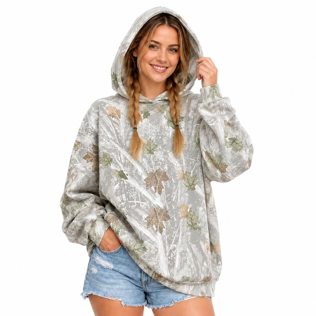 Back view of the printed pullover hoodie on a woman, showing the hood and mixed-color leaf print against a white background.