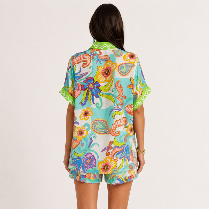 Printed button-down shirt and matching shorts set shown from the back, available in S, M and L, showing the two-piece design.