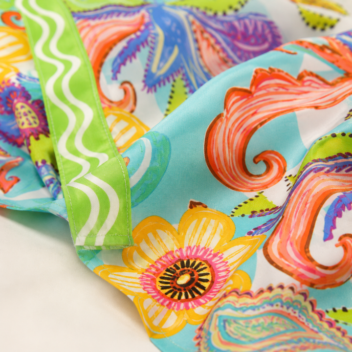 Close-up of printed shirt and shorts set fabric and stitching, with pocket detail, made from 100% polyester, with no stretch.
