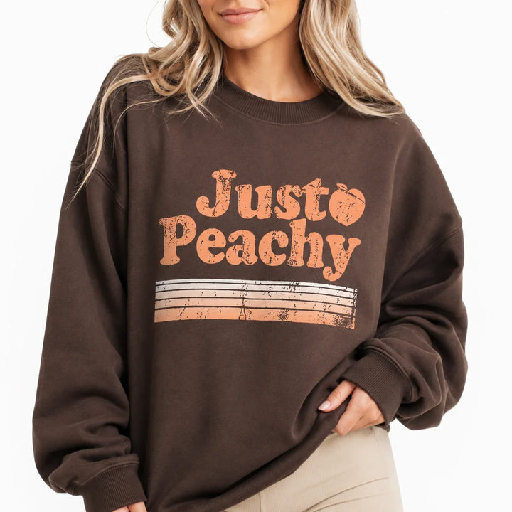 Close-up of Coffee Brown printed sweatshirt for women showing the crew neck, texture and Just Peachy print.