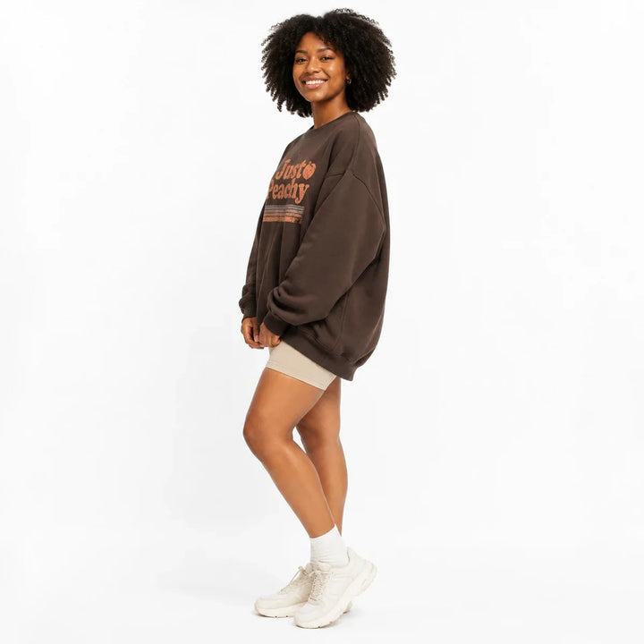 Coffee Brown printed sweatshirt for women in side view showing the relaxed oversized silhouette.
