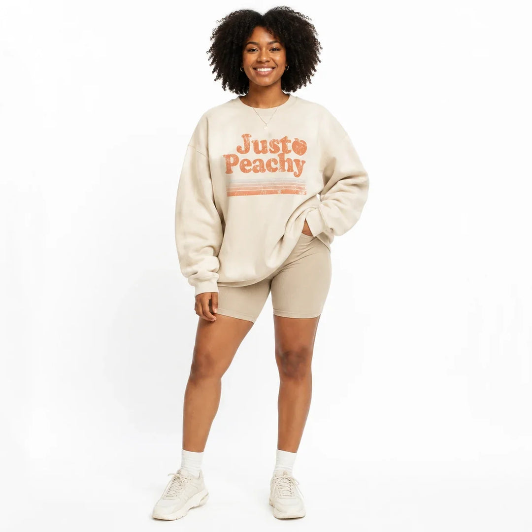 Printed sweatshirt for women in cream, front view with relaxed crew neck fit and Just Peachy graphic.
