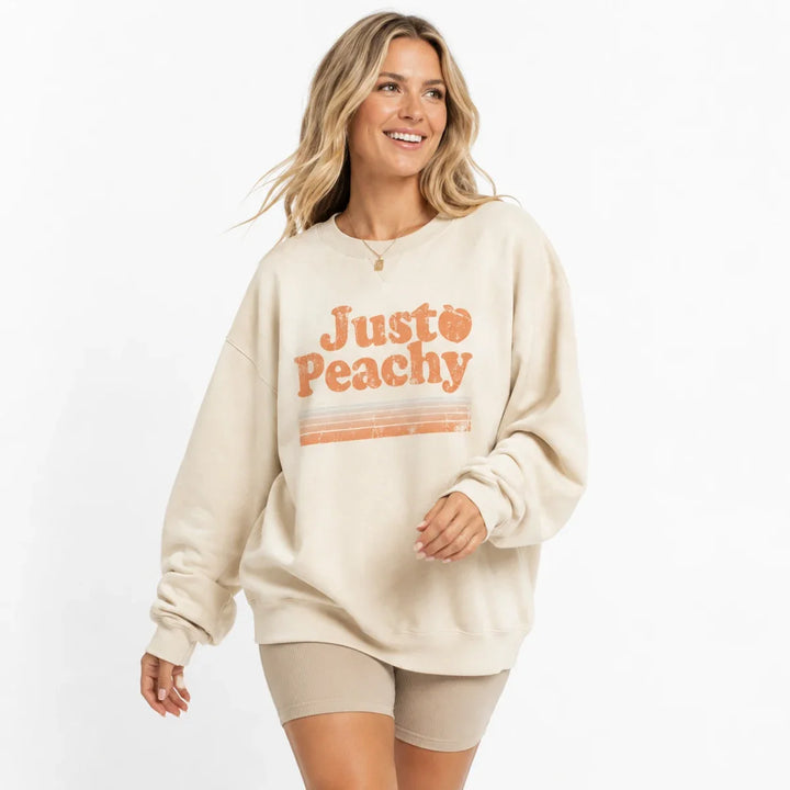 Cream printed sweatshirt for women in a natural movement pose with relaxed crew neck styling.
