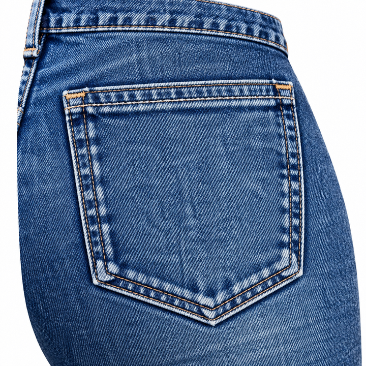Close-up of a blue denim rear pocket and its stitching.