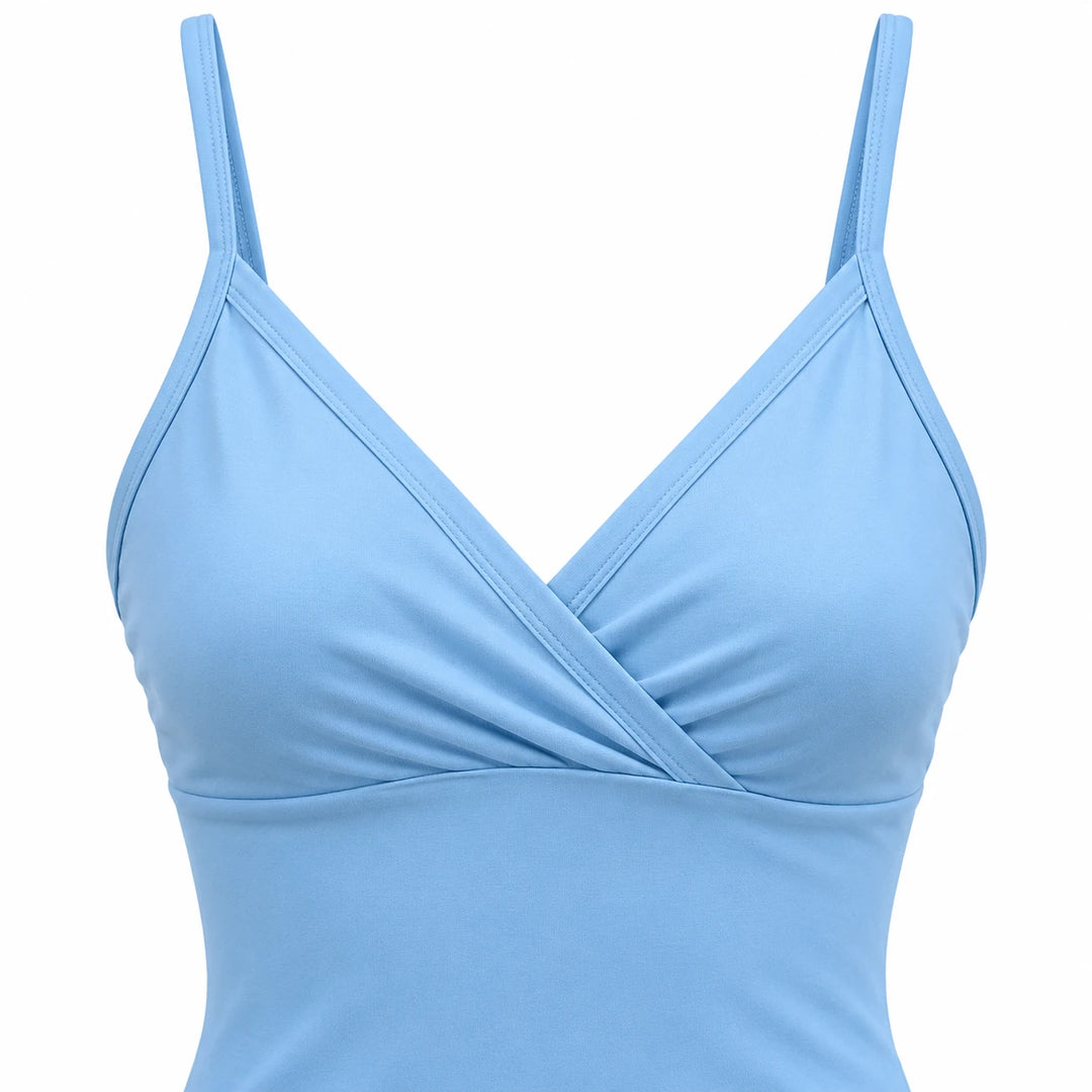 Close-up of the sky blue dress showing its wrap-style V neckline, narrow shoulder straps and seam below the bust.
