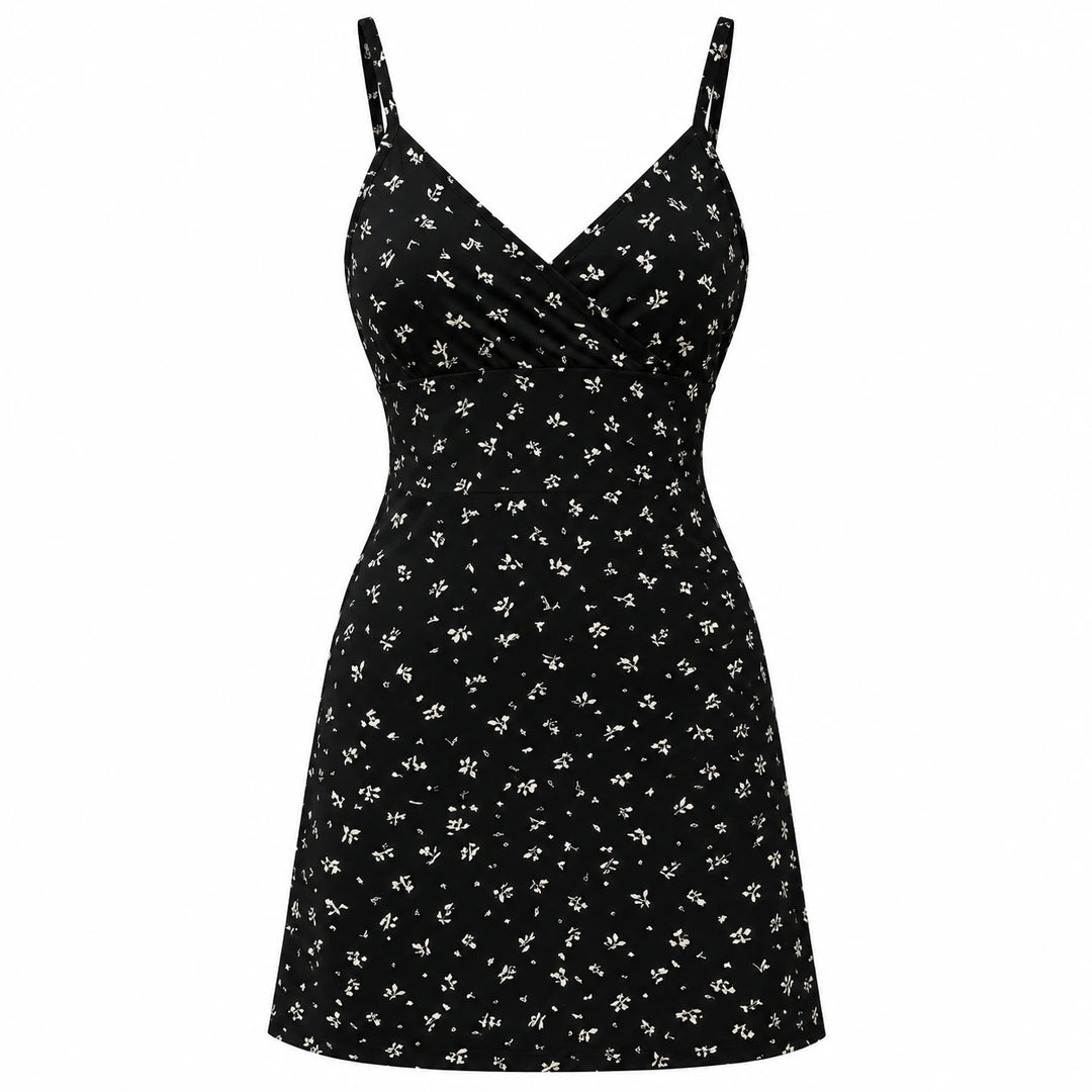 Black mini dress with a small light botanical print, wrap V neckline and thin straps, shown from the front on white.