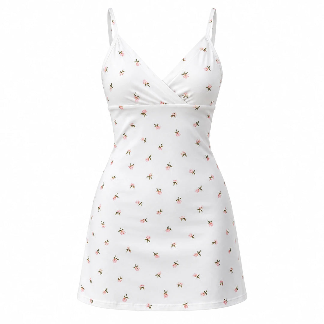 White mini dress with small pink floral sprigs, thin straps and a wrap V neckline, shown from the front on white.