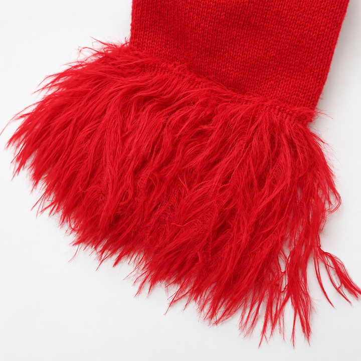 Close-up of the red cardigan feather cuff and visible knit sleeve