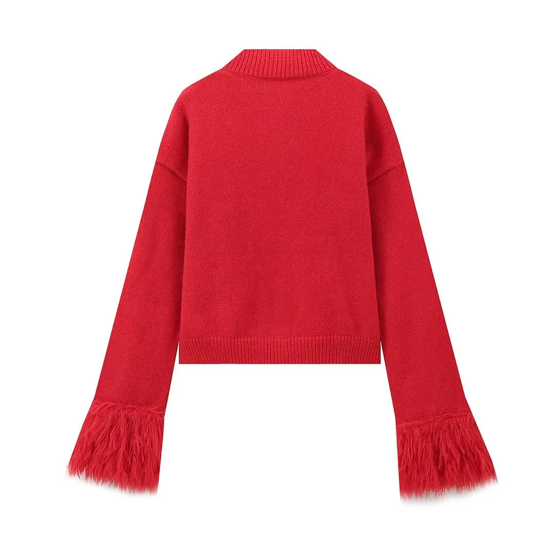 Back view of the red knit cardigan with feather cuffs on a white background