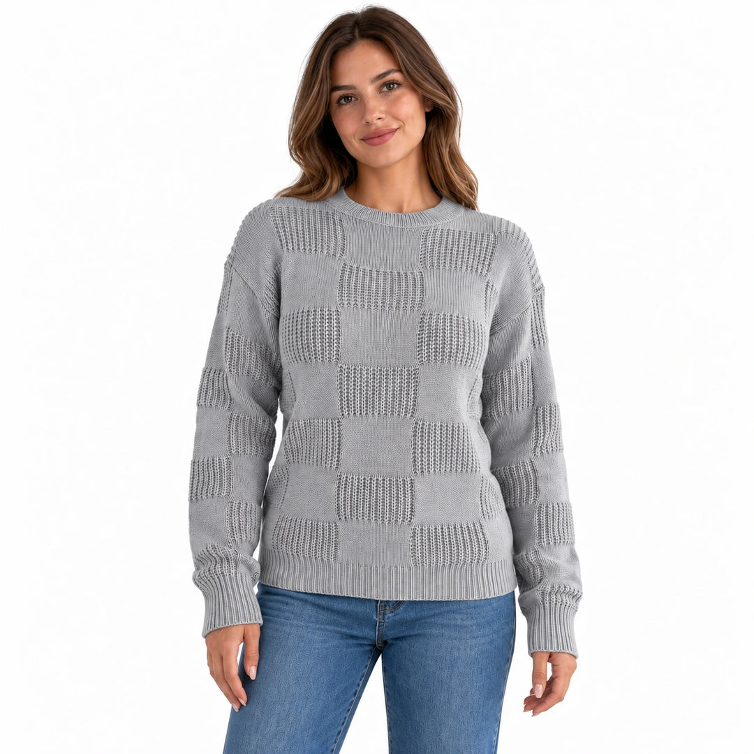 Front view of a model wearing the gray openwork checkerboard knit sweater