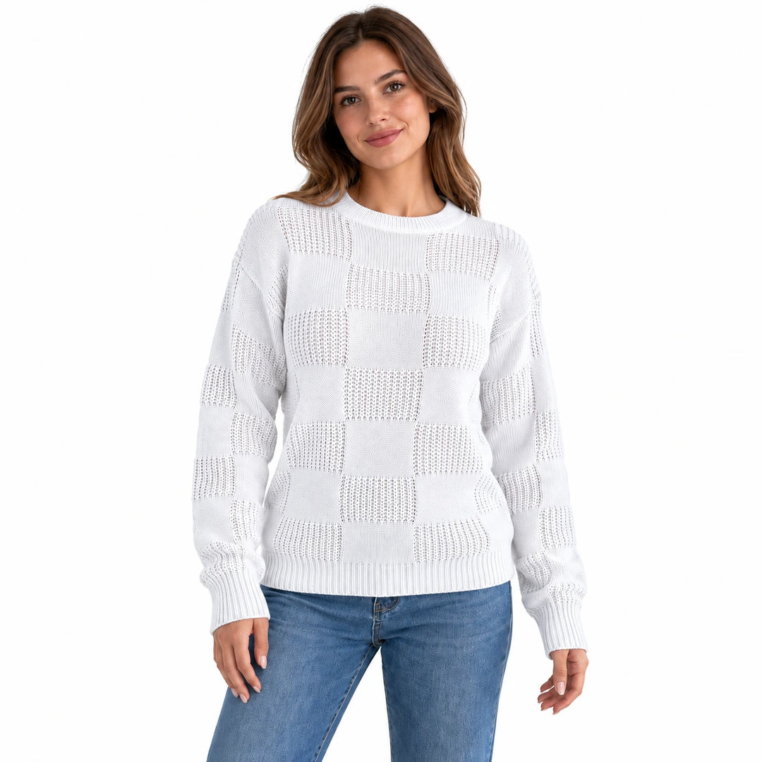 Front view of a model wearing the white openwork checkerboard knit sweater